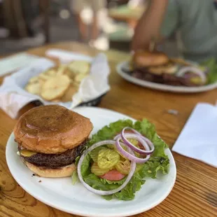 Cheese burger with everything that comes with it