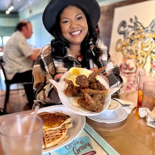  woman sitting at a table with a plate of food