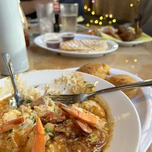 Uptown Shrimp N&apos; Grits. Chicken and waffles in the background