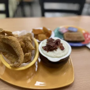 a bowl of grits and a bowl of dip
