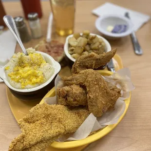 Grits with light Scrambled eggs, English muffins, Country potatoes, Fried chicken wings-2 Pieces and Golden Fried Catfish - 2 Pieces