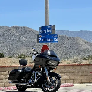 a motorcycle parked in front of a sign