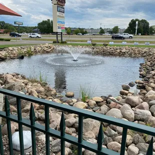 a pond with a fountain in the middle