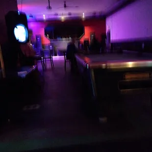 a pool table in a dimly lit room