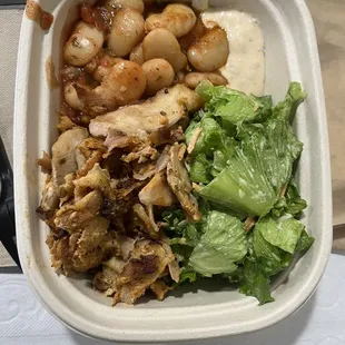 chicken plate kaftero sauce with sides of tomato herb baked butter beans and yogurt lemon garlic tossed salad.