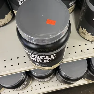 a can of muscle milk on a shelf