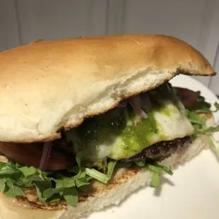 Latin Lover Burger! Roasted Garlic Spread, Sour cream, Muenster, Vine ripened tomato, arugula, lime pickled onion, House Chimichurri Sauce.