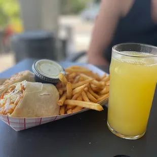 a plate of food and a glass of orange juice