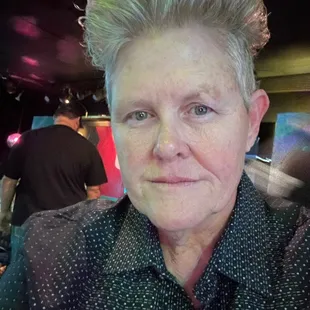 a close up of a woman with short hair