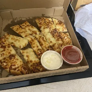 Cheese bread that was cold, hard, and looked dropped.
