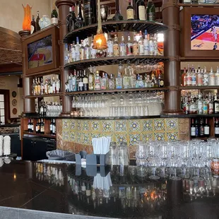 a bar with a lot of bottles and glasses