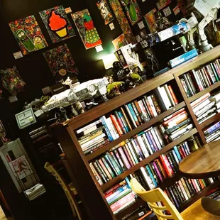 a table and chairs in front of a bookshelf