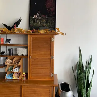 a wooden cabinet with a bird on top