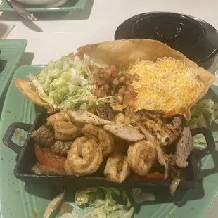 Steak chicken and shrimp fajitas