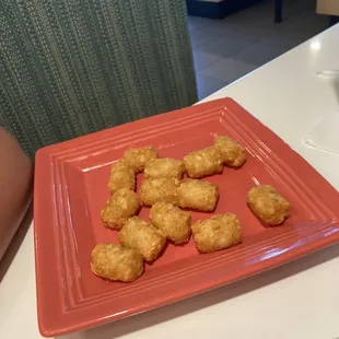 A not so well portioned side of tater tot's