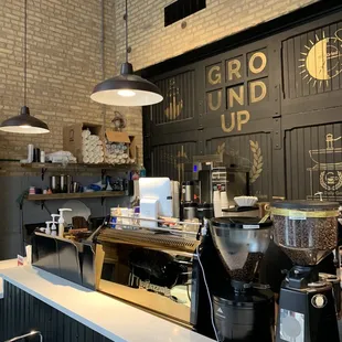 a coffee shop counter with coffee grinders
