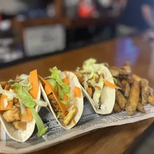 three tacos on a paper plate