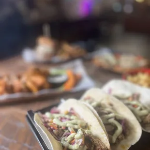 three tacos on a table
