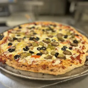 a pizza with olives and peppers