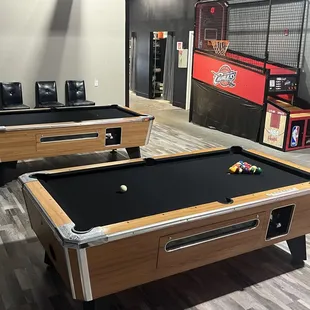 two pool tables in a game room
