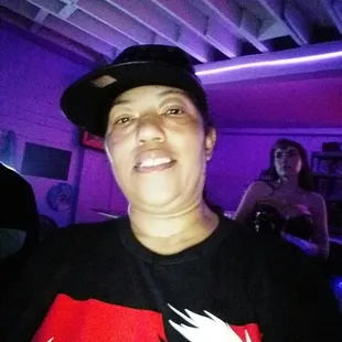 a man in a black hat and a red and white t - shirt