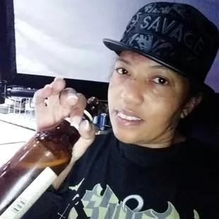 a woman holding a bottle of beer
