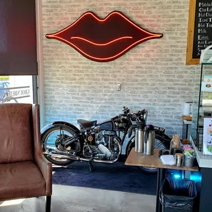 a motorcycle and a neon sign