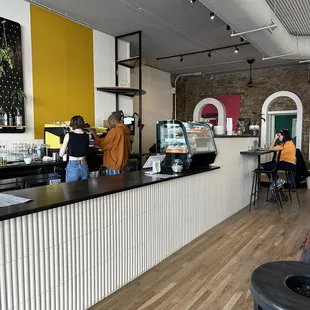 a coffee shop with customers at the counter