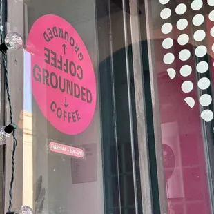 a sign in the window of a coffee shop