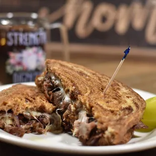 a sandwich and pickle on a plate