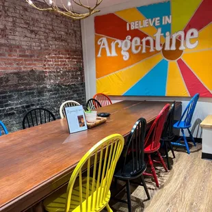 colorful chairs around a wooden table