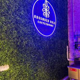 a bar with a green wall behind it