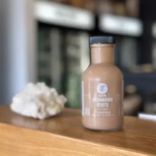 a bottle of grounding coffee on a counter