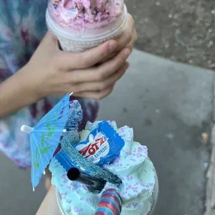 a person holding a cup of ice cream