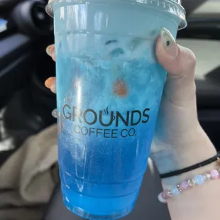 a blue drink in a plastic cup