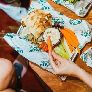 a person holding a plate of food