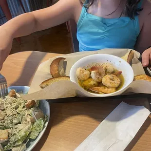 Side Caesar salad and shrimp scampi appetizer.