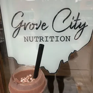 a hand holding a smoothie