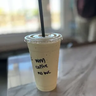 a cup of coffee with a straw
