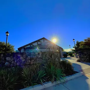 the sun setting over the building