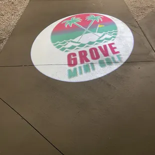 the logo on the sidewalk