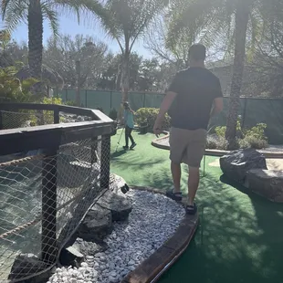 a man playing mini golf