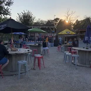 a group of people sitting at outdoor tables