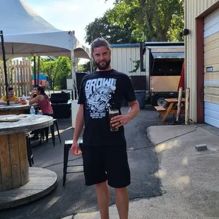 a man holding a beer in his hand