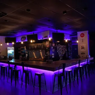 a bar with purple lighting