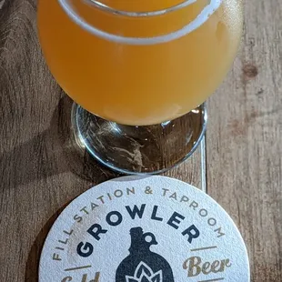 a glass of beer on a wooden table
