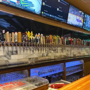 a row of beer taps at a bar