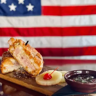 a plate of food on a table with an american flag in the background
