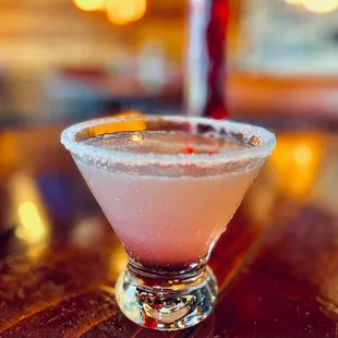 a pink cocktail in a glass