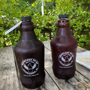 two beer bottles on a picnic table